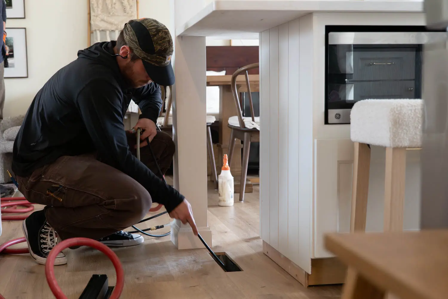HVAC technician inspecting air vent for local SEO and online visibility.