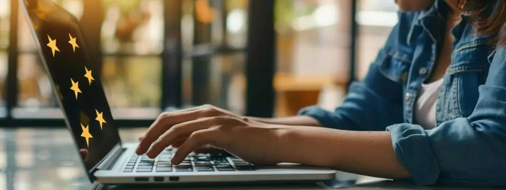 Person typing on laptop with glowing stars, symbolizing online reviews and customer feedback for home service businesses.