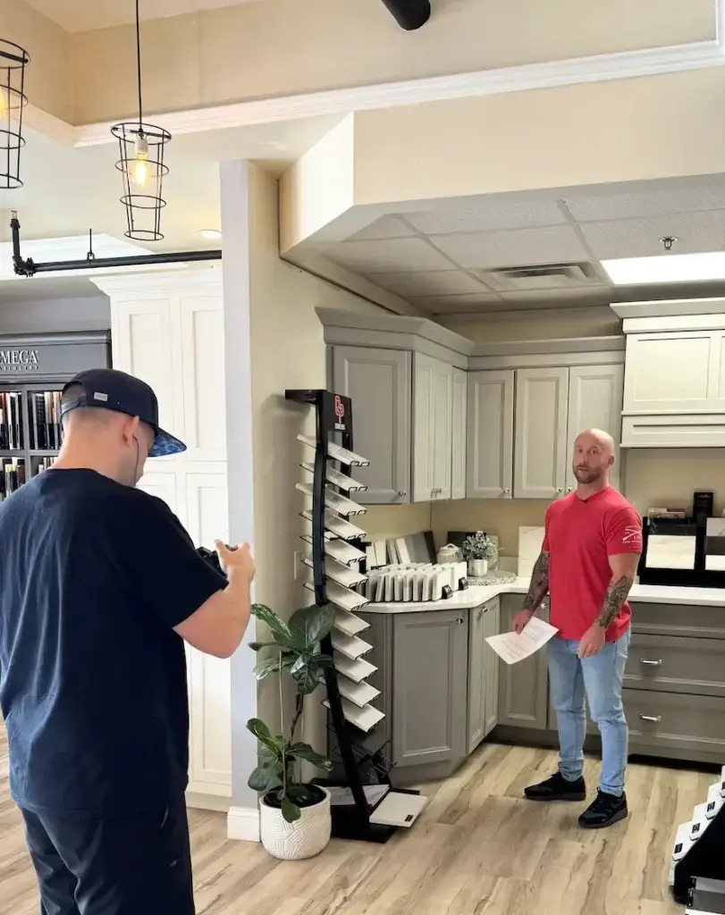 Contractors discussing kitchen remodeling options and design choices in showroom.
