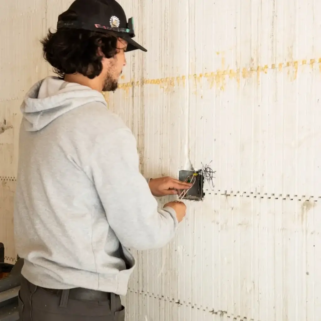 Electrician upgrading home electrical panel for EV charger installation
