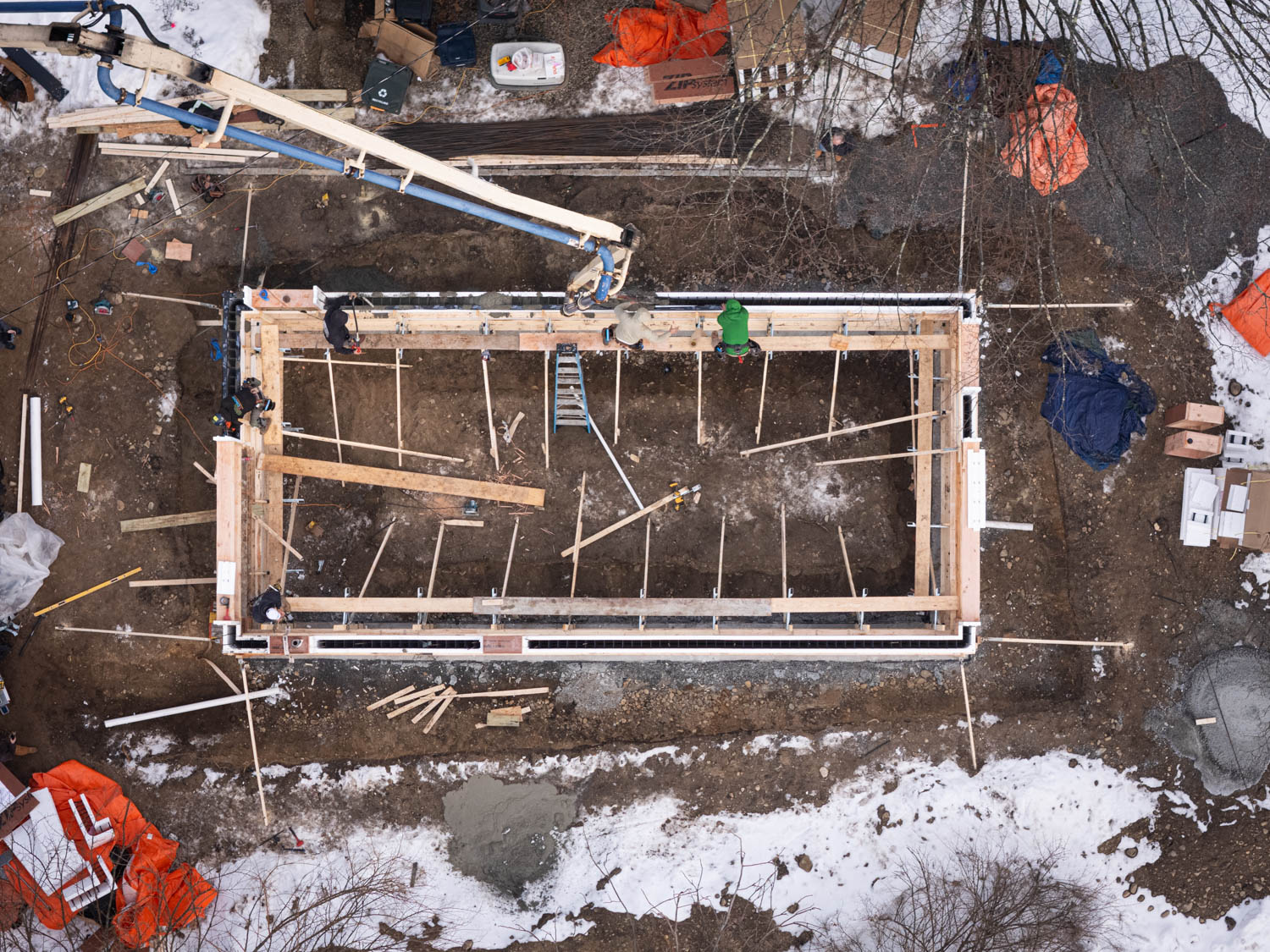 Overhead view of construction site showcasing home framing and building progress for contractors.
